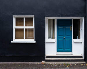 Traditional colourful  house façade with closed window and door in Ireland