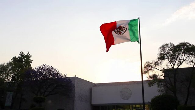 Mexico national flag waving in beautiful sky.