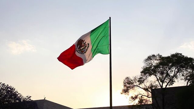 Mexico national flag waving in beautiful sky.