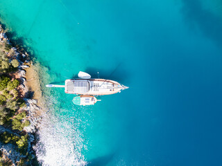 Drone photo capturing a yacht anchored in a picturesque bay in Göcek, Muğla, with its owner...