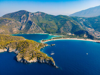 Aerial drone photo of Ölüdeniz, Fethiye, Turkey, showcasing the turquoise waters, picturesque coastline, and beautiful beaches of this popular summer destination. - obrazy, fototapety, plakaty