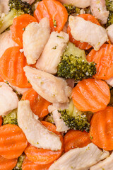 Delicious dish consisting of pieces of boiled chicken, broccoli and carrots