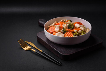 Delicious dish consisting of pieces of boiled chicken, broccoli and carrots