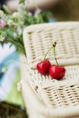 Fototapeta na wymiar Wicker basket and red cherry