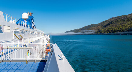 Fototapeta premium Ferry boat cruise ship and vancouver island panorama landscape along Inside Passage cruise in British Columbia between Prince Rupert and Port Hardy, Canada.
