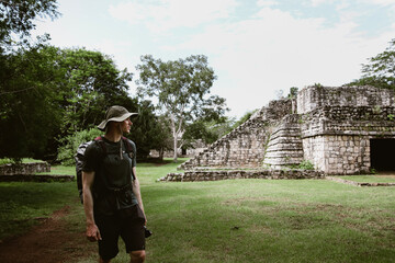 man and Chichen Itza pyramid in Mexico 
