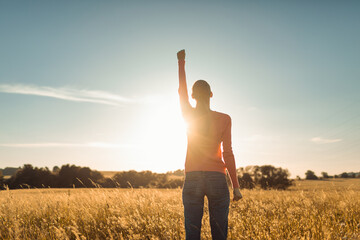 Believe in yourself never give up. Strong confident woman with fist up to the sky 