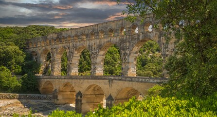 Pont du Gard, a Mighty aqueduct bridge rising over 3 well-preserved arched tiers, built by 1st-century Romans.