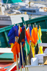 multicolor net marker flags on a traditional fishing boat