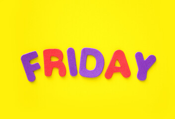 Friday word formed with colorful letters on yellow background with copy space.