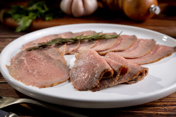 Sliced roast beef on plate.