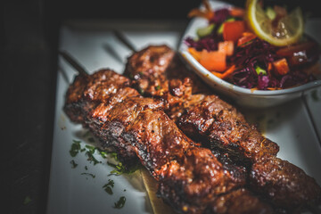 Close-up of well-done lamb shish kebab, juicy, grilled, mouthwatering Mediterranean dish, delicious