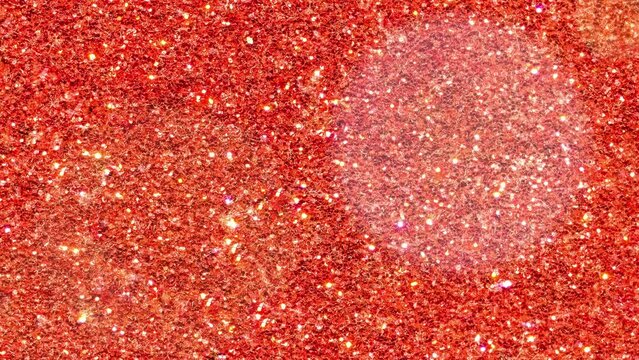 Looped red glitter with bokeh highlights. Abstract festive background with glitters. Stock 4K video with a decorative background of round particles,
