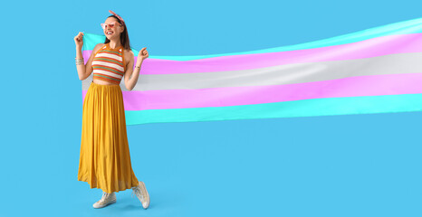 Young woman with transgender flag on blue background