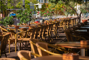 Tables of a cafe restaurant in the street of the city of Willemstad. Curacao.