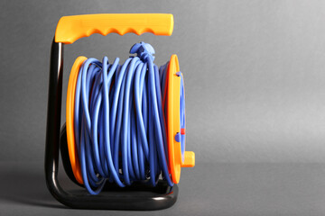 Extension electric cable reel on dark background
