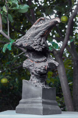 Bronze figure of an eagle bird outdoors on a summer day. Park in the city of Minsk, public places.