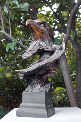 Bronze figure of an eagle bird outdoors on a summer day. Park in the city of Minsk, public places.