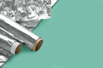 Rolls of aluminium foil on color background