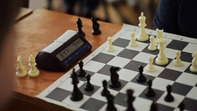 Chess grandmasters playing speed chess with a chess clock.