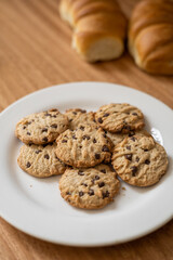 appetizing chocolate chip cookie wallpaper, sweet and healthy food, texture in studio, homemade snack with breads in the background