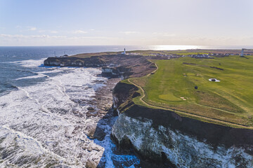 Drone panoramic view of the Flamborough Head green chalk cliffs and the North Sea in sunny weather. High quality photo