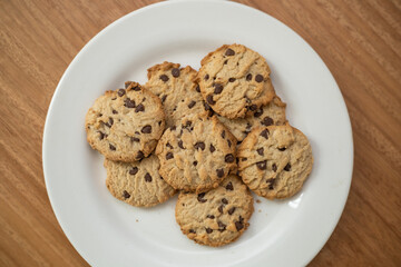 details of delicious cookies decorated with chocolate chips, pastry in studio, food and dessert texture