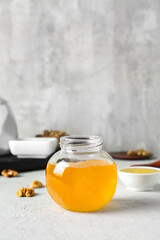 Jar of sweet honey on table
