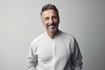 Portrait of a smiling mature man in a white sweatshirt.