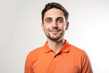 Fototapeta premium Portrait of a handsome young man in orange t-shirt on white background