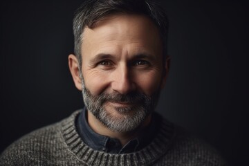 Portrait of a handsome middle-aged man in a gray sweater
