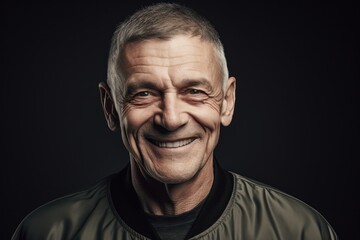 Obraz premium Portrait of a smiling senior man. Isolated on black background.