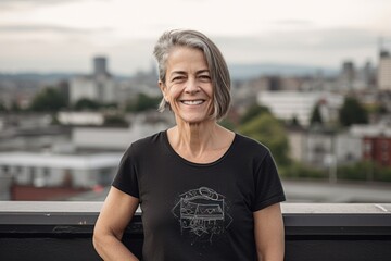 Portrait of a beautiful middle-aged woman with short gray hair against the background of the city