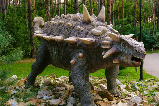 Belgorod, Russia - September 06, 2021: Ankylosaurus statue in the pine forest of Belgorod dinopark. Herbivorous dinosaur.