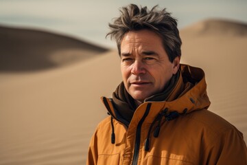 Obraz premium Portrait of a middle-aged man in yellow jacket in the desert.