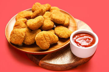Plates of tasty nuggets and ketchup on red background