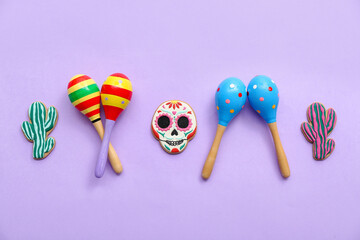 Mexican maracas with cookies on lilac background
