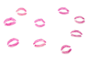 Pink lipstick kiss marks on white background