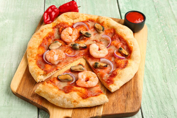 Board of tasty seafood pizza on light wooden background