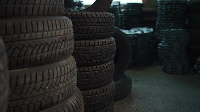 stack of car wheel tires at modern warehouse or retail automotive shop