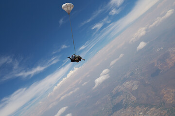 Skydiving. Tandem jump. An instructor and passenger are in the sky.