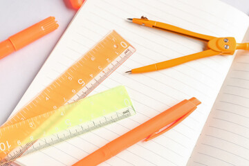 Notebook and stationery supplies on white background