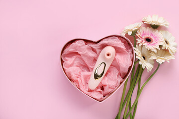 Gift box with vibrator and flowers on pink background - obrazy, fototapety, plakaty