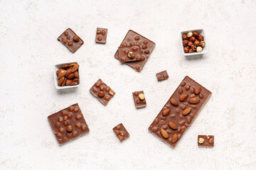 Sweet tasty chocolate with nuts on  light background