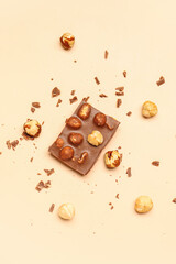 Sweet tasty chocolate with nuts on  beige background