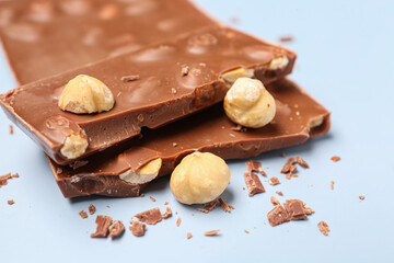 Sweet tasty chocolate with nuts on  light background, closeup