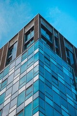 Fototapeta premium Tower block office building windows reflective glass blue sky tall architecture buildings, office block finance buildings, flats and apartments corporate structure skyscraper