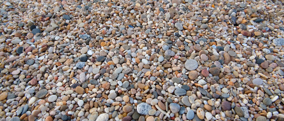 Pebbles on beach. Worn smooth by the ocean. Natural background.