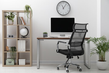 Workspace with desk, chair and computer at home