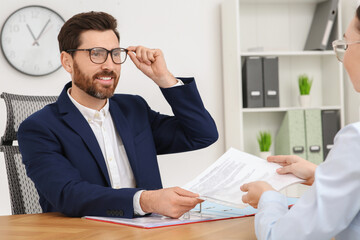 Businesspeople working with documents at table in office